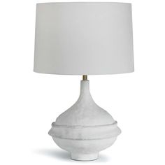 a white table lamp with a white shade on it