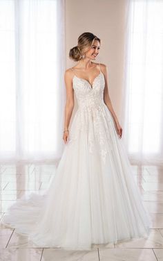 a woman in a wedding dress standing on a tile floor