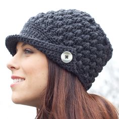 a woman wearing a crocheted hat with a button on the front and side