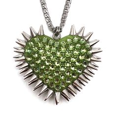 Crafted with care in our Cleveland studio, this iconic pendant features a striking spiked heart design and dozens of hand-placed, iridescent crystals. DETAILS Heart Charm: 2" wide Chain: stainless steel or gold plated THE COLOR Peridot is a delicate, yellow-green hue reminiscent of sunlit meadows. Its shimmering, pale green shades, known as the 'evening emerald,' evoke feelings of renewal and spiritual connection, casting a dreamy, enchanting allure. SIZE CHART Trendy Heart Shaped Rhinestone Jewelry, Silver Heart-shaped Punk Jewelry, Punk Style Heart Pendant Jewelry With Heart Charm, Green Heart-shaped Jewelry For Party, Edgy Heart Charm Jewelry For Valentine's Day, Green Heart-shaped Party Jewelry, Silver Punk Heart Pendant Jewelry, Edgy Heart-shaped Chain Jewelry, Punk Style Heart-shaped Metal Jewelry