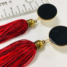 "This black and red stud tassel earrings have the chic touch for your any outfit. The earrings are made in Silk, gold plated brass and leather. Is a simple and statement design. In the top a gold plated brass stud with a leather cabochon, hanging a handmade silk tassel. Total Length 15 cm , 6 inches Ask me if you want a different colors or length ! If you want Express shipping ( Dhl delivery in 2-5 days) You'll see a drop down menu that says \"Standard Shipping \" to the right of your item. If y Trendy Red Tassel Earrings, Chic Black Earrings With Fringe, Chic Black Fringe Earrings, Black Drop Tassel Earrings As Gift, Black Tassel Earrings As Gift, Black Tassel Earrings For Gift, Black Tassel Earrings For Evening, Elegant Red Tassel Earrings With Fringe, Black And Red Earrings