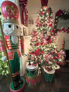 a christmas tree and nutcrackers are in front of a decorated christmas tree