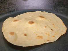 an uncooked tortilla in a frying pan