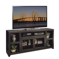 an entertainment center with a flat screen tv on it's side and shelves below