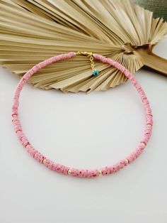 Handcrafted beaded necklace with soft clay beads and golden beads. Beads size: 5cm. Lobster claw closure.  Length of necklace: 41cm (16 inches) + extension chain. Color: marble pink. Pink Heishi Beads Necklace, Pink Heishi Beads Necklace With Tiny Beads, Handmade Pink Heishi Beads Necklace, Pink Heishi Beads Necklace For Gift, Pink Tiny Beads Vacation Jewelry, Pink Tiny Beads Jewelry For Vacation, Pink Heishi Bead Necklace With Colorful Beads, Pink Necklace With Colorful Heishi Beads, Pink Beaded Choker Necklace For Beach