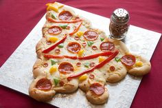 a pizza with pepperoni, cheese and peppers sitting on top of a paper towel