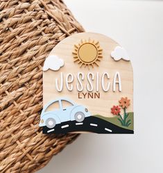 a wooden sign that says, uessica lynn next to a wicker basket