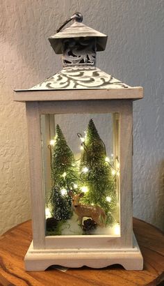 a small white lantern with christmas lights in it