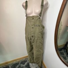 This Vintage Overall Was Issued To The Us Navy Contractor Nxsx38052 And Is In Fantastic Condition. This Would Have Been Used As A Deck Bib On A Warship During Ww2! Lined With Fleece, Adjustable Straps, Original Buttons, No Staining, Stenciled Usn Size Medium Measurements: 42” Waist 49” Hip 22” Rise 29” Inseam All Vintage Clothing In My Shop Has Been Worn Previously - Meaning We’re Just The Middle Man On Trying To Get These Guys New Loving Homes. All Are As-Is And By Purchasing From Us You Agree To This. Utility Style Overalls With Belt Loops, Utility Overalls With Belt Loops, Green Workwear Overalls, Green Overalls For Work, Cotton Overalls With Belt Loops, Overall Pants, Middle Man, Bib Overalls, Vintage Pants