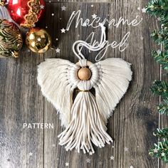 an angel ornament on a wooden surface with ornaments around it