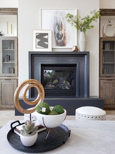 a living room filled with furniture and a fire place in the middle of the room