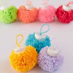 small pom - poms are lined up in different colors