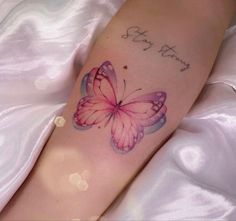 a woman's foot with a pink butterfly tattoo on the left side of her leg