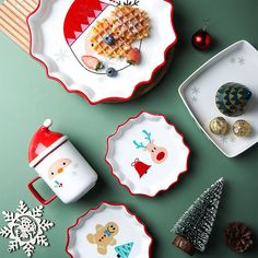 three plates with christmas designs on them next to some pine cones and other holiday decorations