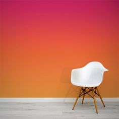 a white chair against an orange and pink wall