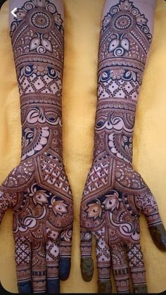 two hands with henna designs on them