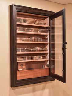 an empty glass doored cabinet with many items in the shelves and on the wall