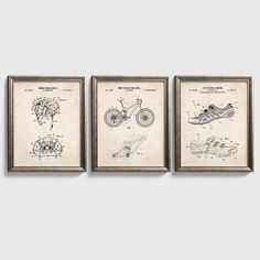 three framed drawings of motorcycles are hanging on the wall