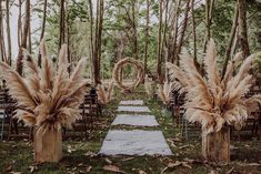 an outdoor ceremony setup with pamodia and aisle