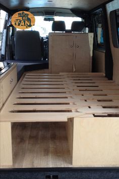 the back end of a van with wooden slats on it's bed area