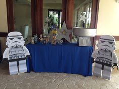 star wars themed decorations are on display in front of a blue table cloth covered table