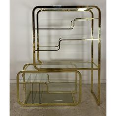 two metal and glass side tables on wheels