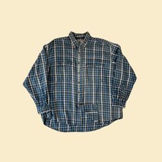 Vintage flannel shirt, manufactured ca. late 1990s - early 2000s by High Sierra. Button-down long sleeve shirt with a medium-thickness fabric and two front pockets with button closures. Size XL.   - Time Period: c. late 1990s - early 2000s  - Brand: High Sierra  - Size: XL  - Colors: Blue, yellow, green, white  - Materials: Cotton  - Made in: Indonesia  - Condition: In good, vintage condition w/ some minor nicked threads and faint pink markings on one of the arms. Measurements:   - Armpit to arm Blue Flannel Shirt With Pockets, Blue Flannel Shirt With Relaxed Fit, Blue Relaxed Fit Button-up Flannel Shirt, Blue Long Sleeve Flannel Shirt With Pockets, Oversized Blue Flannel Long Sleeve Shirt, Oversized Blue Long Sleeve Flannel Shirt, Blue Long Sleeve Flannel Shirt With Button Closure, Blue Long Sleeve Flannel Shirt With Buttons, Long Sleeve Blue Flannel Shirt