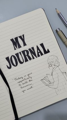 a notebook with the words my journal written on it next to a pen and pencil