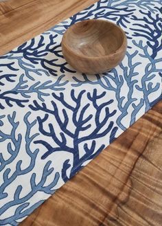 a wooden bowl sitting on top of a blue and white rug