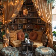 a living room filled with lots of furniture and lights hanging from the ceiling above it