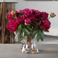 a vase filled with pink flowers on top of a table