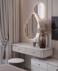 a white dresser with a mirror and vase on it