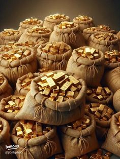 bags filled with gold bars sitting on top of each other