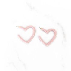 Add some love to your outfit with these charming Light Pink and White Open Heart Earrings. These sweet earrings feature an open heart design in light pink and white, adding a touch of sweetness to any look. Perfect for a romantic date or a fun night out with friends! Open Heart Earrings, Sweet Earrings, Romantic Date, Romantic Dates, Open Heart, A Romantic, Heart Earrings, Heart Design, Pink And White