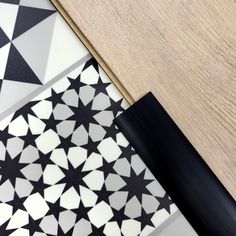 the floor is made up of black and white geometric tiles, which have been placed on top of each other