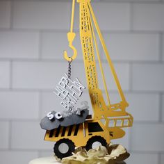 a yellow and black cake with a crane on top