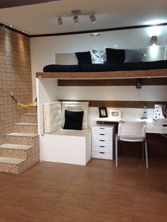 there is a loft bed in the middle of this room with stairs leading up to it