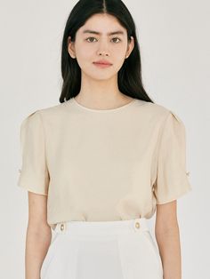 This product is an elegant half jewel blouse designed to add a touch of sophistication to any outfit. It features short sleeves with delicate jewel details and a classic round neckline. The blouse is crafted from a high-quality fabric that ensures comfort and a flattering fit. - This half jewel blouse has jewel embellishments on the sleeves, adding a subtle sparkle.- The round neckline provides a timeless and versatile look.- The short sleeves are designed for a comfortable and stylish fit.- The high-quality fabric ensures durability and a flattering silhouette. Elegant Solid Color Blouse With Crew Neck, Elegant Cream Crew Neck Top, Elegant Beige Crew Neck Blouse, Chic Crew Neck Short Sleeve Top For Work, Elegant Puff Sleeve Tops, Elegant Short Sleeve Tops For Summer, Elegant Short Sleeve Summer Tops, Elegant Beige Puff Sleeve Top, Feminine Cream Short Sleeve Blouse