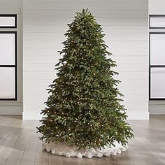 a christmas tree is in the middle of an empty room