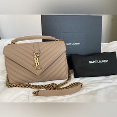 Brand New In Box With Dust Bag And Papers! Authentic Medium Ysl College Bag With Gold/Bronze Hardware. Bought In Ysl Store In Las Vegas 10/2022 Right Before Their Price Increase And Never Used It. Sadly Their Return Policy Is Store Credit Only. I Purchased Their Last One And There Was Already A Minor Imperfection On The Top Flap Inside Which Didn’t Really Bother Me. Please See Last Pic. Has A Top Handle With A Removable Chain. Can Worn Crossbody. Feel Free To Ask Questions! Thanks For Looking! S Medium College Bag Ysl, Ysl College Bag Medium Beige, Ysl College Bag Medium, Tan Ysl Bag, Cream Ysl Bag, Ysl College Bag, Ysl Store, Yves Saint Laurent Bag Beige, Ysl College