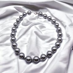 Introducing our stunning beaded grey choker, the perfect accessory for adding a touch of elegance to any outfit! Handcrafted with care, this beautiful choker features a delicate string of grey beads that have been intricately woven together to create a stunning, eye-catching design.   The neutral grey color makes this choker incredibly versatile, allowing it to be worn with a wide range of outfits and styles. Whether you're dressing up for a night out on the town or adding a touch of sophistication to your everyday look, this choker is the perfect choice.   Made with high-quality recycled materials and finished with a secure clasp, this choker is built to last and will quickly become a staple in your jewelry collection. So why wait? Treat yourself or someone special to this beautiful beade Recycled Necklaces, Beautiful Chokers, Gray Jewelry, Grey Beads, Of Outfits, Choker Necklaces, Bridal Necklace, Beaded Choker, Bridesmaid Jewelry