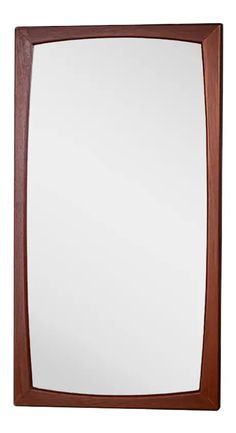 a wooden framed mirror on a white background