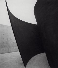 a black and white photo of an abstract sculpture in the shape of a curved triangle