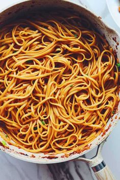 a large pot filled with spaghetti on top of a table