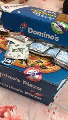 two boxes of domino's pizza on a table