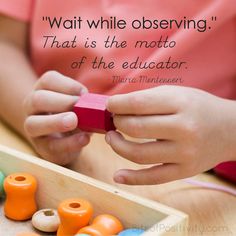 a child is playing with wooden beads in a box that says, wait while observing