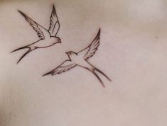 a small bird tattoo on the back of a woman's left shoulder and chest