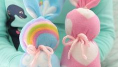 two stuffed animals sitting next to each other in front of a woman's face