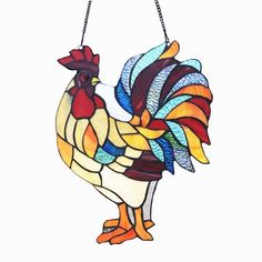 a stained glass rooster hanging from a chain on a white background with the words,