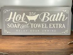 a metal sign that says hot bath and towel extra relax soak unwinded